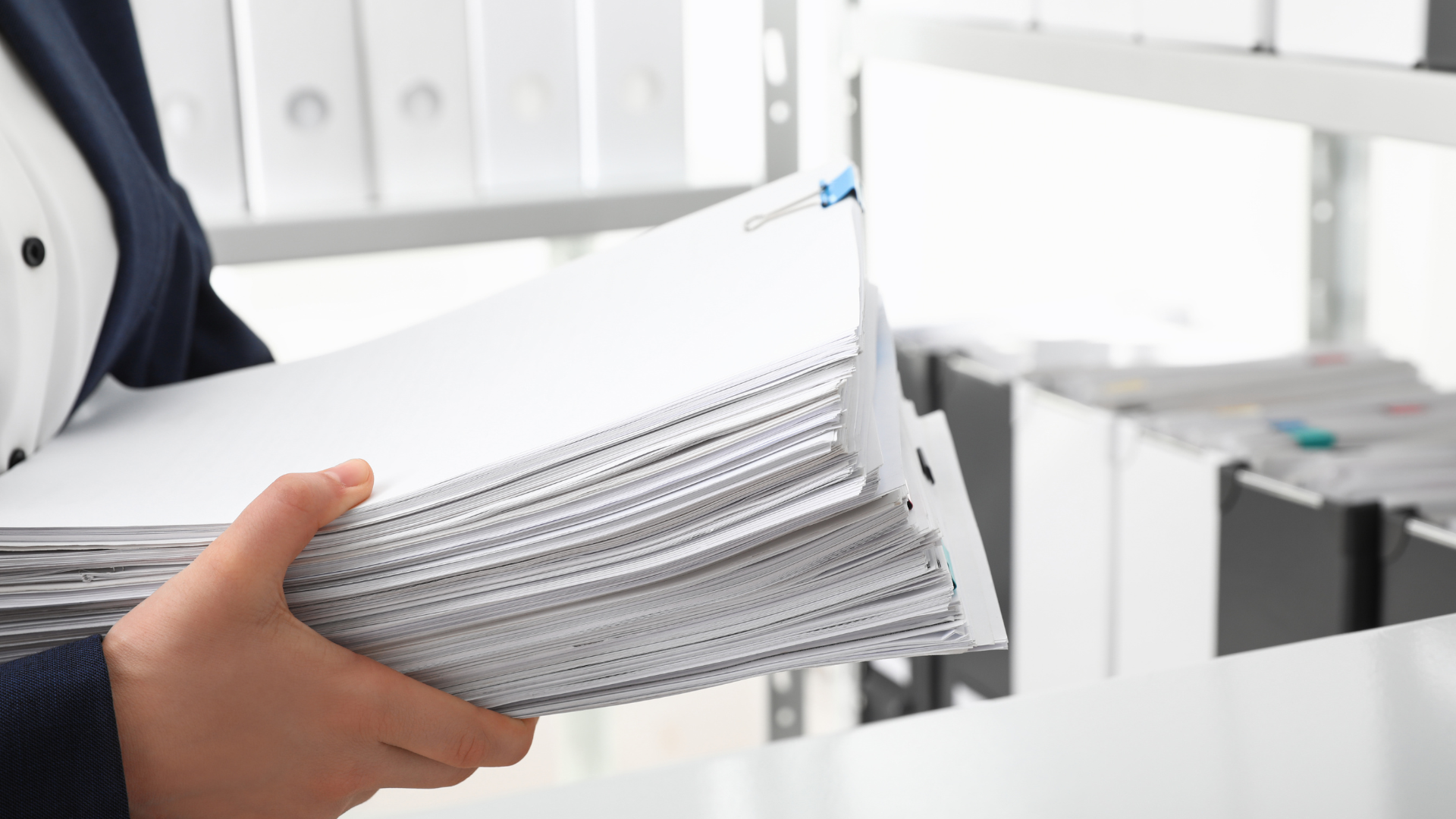 An image of a law clerk in Ottawa who is handling paper files that are in need of litigation coding and e-discovery services for trial